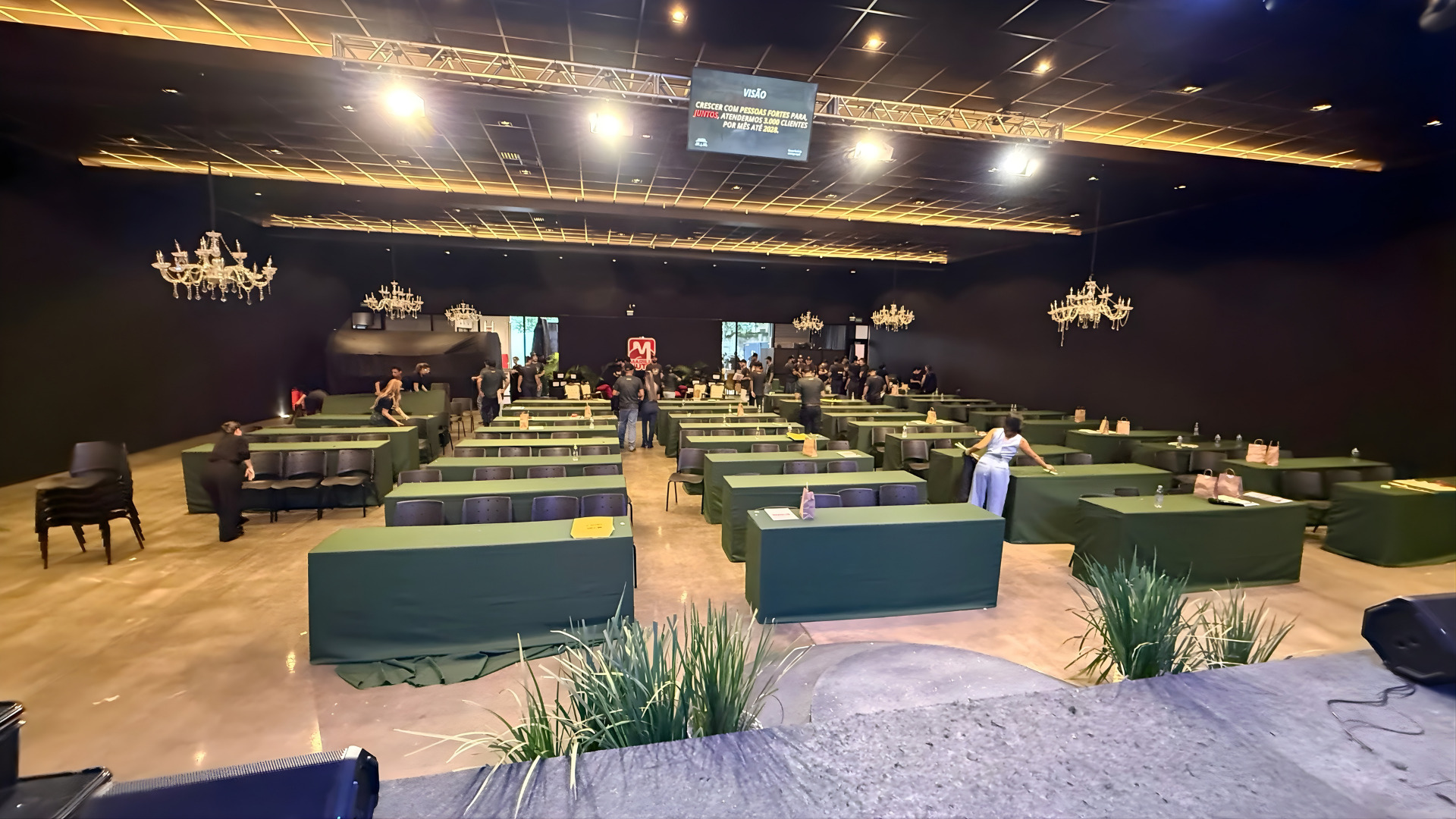 Mesa de mixagem de áudio com técnico operando durante evento corporativo